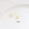 Macro detail of 4mm gold-plated flat stud earring posts for DIY jewelry making - 4mm / 18K Gold