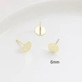 Macro detail of 6mm gold-plated flat round earring studs with polished surface finish - 6mm / 14K Gold