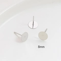 Macro view of 8mm silver metal flat base earring posts for DIY jewelry making - 8mm / White Gold
