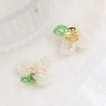 Macro shot of handmade beaded glass flower accessories with intricate wire craftsmanship - White