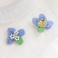 Handmade beaded flower earrings with blue crystal petals and gold metal base detail - Blue