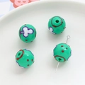 Close-up of green acrylic round beads with clover patterns for DIY jewelry making - Green Clover Polka Dot (8#)