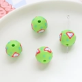 Macro shot of green acrylic heart-patterned beads for DIY jewelry making and crafts - Grass Green Heart Blue Dot (11#)
