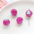 Macro shot of purple acrylic floral beads with white clover and red flower patterns - Purple Clover Red Flower (14#)