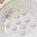 Macro view of iridescent white ceramic cat paw beads for DIY jewelry and necklaces - White