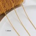 Close-up of 1.4mm gold plated ball chain on a white plate for DIY jewelry making - 18K Gold Plated 1.4mm Bead Chain