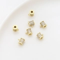 Macro shot of gold plated cylinder charms with micro-pave cubic zirconia for DIY jewelry - 14K Gold