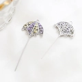 Macro detail of gold-plated umbrella jewelry pins with colorful zircon inlay and filigree - Umbrella Pendant Style / Silver