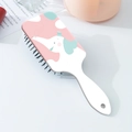 Close-up of a white hairbrush featuring a cute cartoon elephant on a pink background - Elephant with Top Hat Pattern (B)