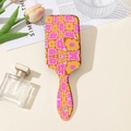 Detailed close-up of a pink and yellow floral checkered air cushion hairbrush with hang hole - Pink Ginger Checkerboard Floral (Style A)