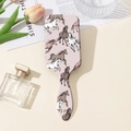 Flat lay of pink air cushion hairbrush with running horse print and floral decor - Light Pink Running Horse (A)