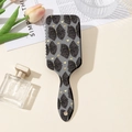 Dettaglio della spazzola per capelli con fiocchi su sfondo elegante e raffinato - Base Grigia Motivo Fiocco Cuore Nero (D)