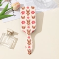 Detail of Highland Cow print paddle brush with floral patterns and ergonomic handle hole - Highland Cow Pattern (A)
