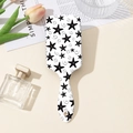 Detailed close-up of a white hairbrush with black starfish prints and ergonomic handle - Sea Star Print Style (A#)
