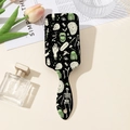 Flat lay of retro skull print hairbrush with pink tulips and a perfume bottle - Black Horror Print (Style B)