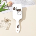 Detail showing a white air cushion hairbrush with cute sloth cartoon print and soft bristles - White Sloth (B)