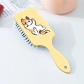 Close-up of cute calico cat printed hairbrush with air cushion and hanging hole design - Light Yellow Calico Cat Pattern