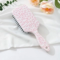 Detail of pink leopard print hairbrush with air cushion bristles and handle hanging hole - Purple Leopard (C)