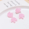 Macro detail of four pink glass flower beads for DIY jewelry making in a white tray - Pink Flower
