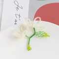Detail of handmade beaded flower pendant with crystal petals and green stem accents - White Double Flower