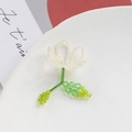 Detail of handmade beaded flower brooch with white petals and green crystal leaves - White Single Flower