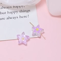 Macro view of purple star-shaped resin beads with yellow inner stars for DIY jewelry - Purple Star