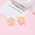 Macro detail of acrylic resin flower beads for DIY crafts with metal pins on pink backdrop - Light Orange Flower
