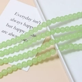 Close-up of 8mm light green macaron glass beads for DIY jewelry making and handmade crafts - Single Piece / Green