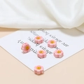 Detailed view of pink flower ceramic beads with smiley face for DIY jewelry crafting - Pink Smiley Small Flower