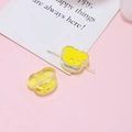Detail of yellow resin bear bead with a needle showing the DIY threading hole for jewelry - Yellow Bear