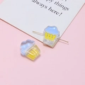 Detail of cupcake-shaped resin beads in blue and yellow for DIY jewelry making crafts - Blue Yellow Cupcake