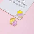 Macro detail of cupcake shaped resin beads for DIY jewelry with pink backdrop - Yellow Purple Cupcake