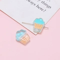 Macro view of blue and orange cupcake resin beads with metal pins for DIY jewelry making - Sky Blue Cupcake