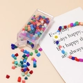 Close-up of colorful 4mm seed beads in a storage box with a flower charm bracelet - 10g Per Box / Multicolor Mixed