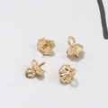 Close-up of 4 gold plated bell shape bead caps with peg and loop for jewelry making - Large Flower Shaped Gold