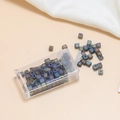 Macro detail of iridescent square glass seed beads with storage box for jewelry making - Brown