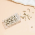 Detail of 4mm silver frosted glass tube beads in a clear box for DIY jewelry making - Light gold
