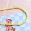 Close-up of pastel yellow macaron ceramic beads for DIY jewelry and necklace crafting - Milky Yellow (4#)