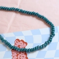 Macro detail of teal ceramic beads with iridescent finish for DIY jewelry making - Brown (11#)