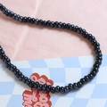 Close-up of polished black ceramic macaron beads for DIY jewelry making and necklaces - Black (12#)