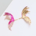 Detail of gradient enamel feather wing earrings with gold-plated finish and intricate texture - K Gold
