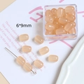Détail de perles barils en résine abricot 6x9mm pour la création de bijoux et DIY - Orange Clair
