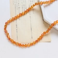 Gros plan de perles en cristal facetté orange pour bijoux et colliers faits main - Style Facetté Classique / Iridescent Orange Yellow