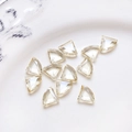 Macro shot of 12 champagne triangular glass beads for DIY jewelry on a ceramic plate - Light Yellow