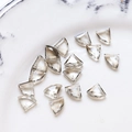 Macro shot of smoky gray triangular faceted glass beads for DIY jewelry making in a tray - Gray