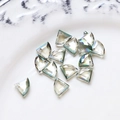 Macro view of multi-faceted iridescent crystal glass beads for DIY jewelry making - Dark Green