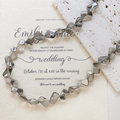 Macro shot of smoky grey faceted glass beads on textured stone and wedding invites - 1 Strand (Approx. 46 Beads) / Gray