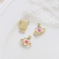 Close-up of pink heart planet charms with gold alloy base and zirconia inlay details - Gold Gradient Heart
