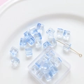 Macro detail of transparent light blue square glass beads with center holes for DIY jewelry - 20 Pieces Pack / Blue