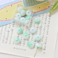 Macro detail of gradient green glass beads with transparent finish and storage box - 10 Pieces Pack / Green